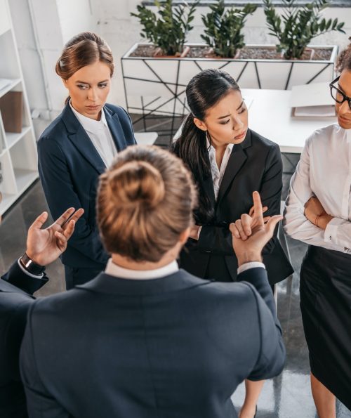 young-coworkers-in-formalwear-arguing-at-business-meeting-in-office-business-team-meeting.jpg